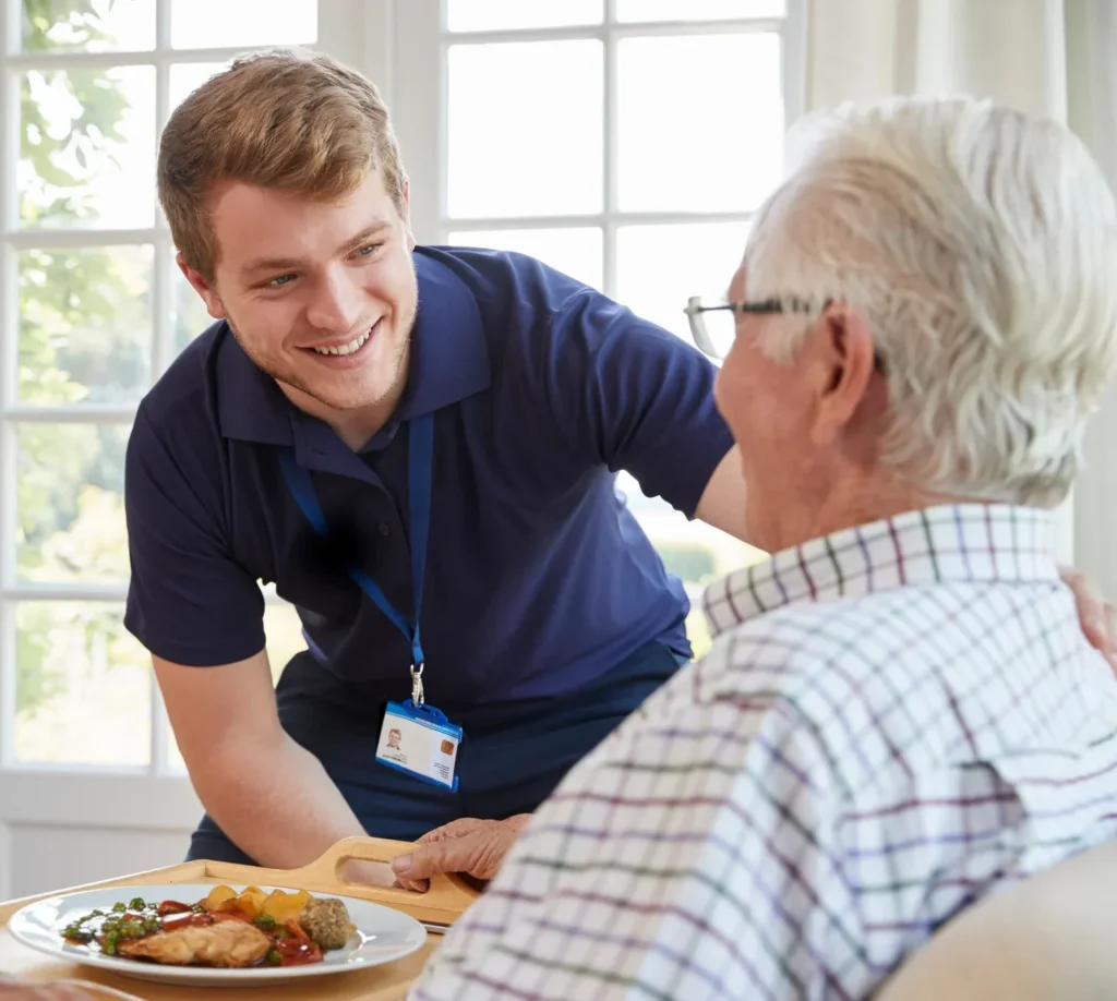 A caregiver smiling with a resident.