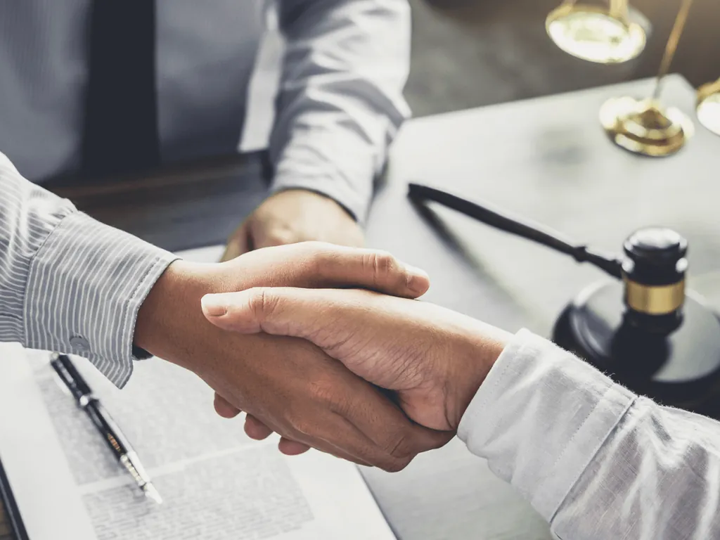 Advocate shaking hands with client after Medicaid asset protection appeal in Pennsylvania